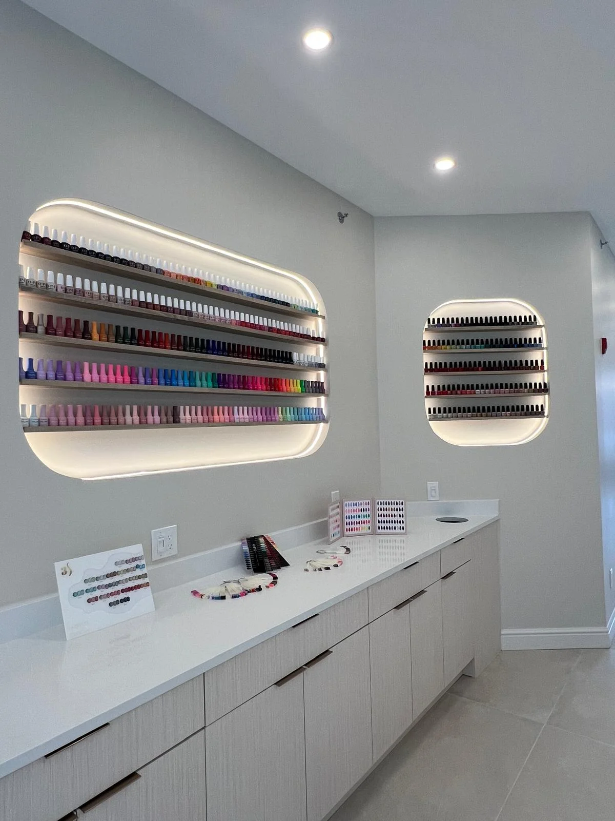 Polish display walls — back-lit niches over quartz vanity