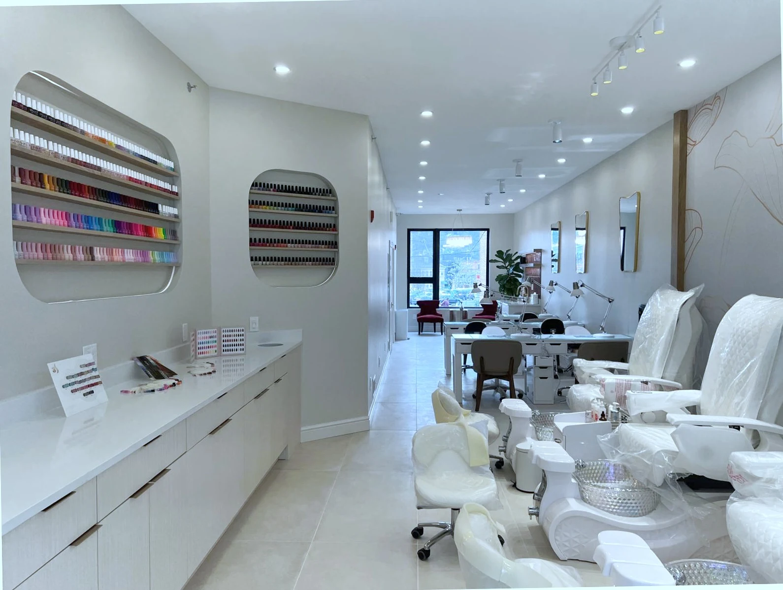 Salon interior &mdash; mani stations and lotus mural at back