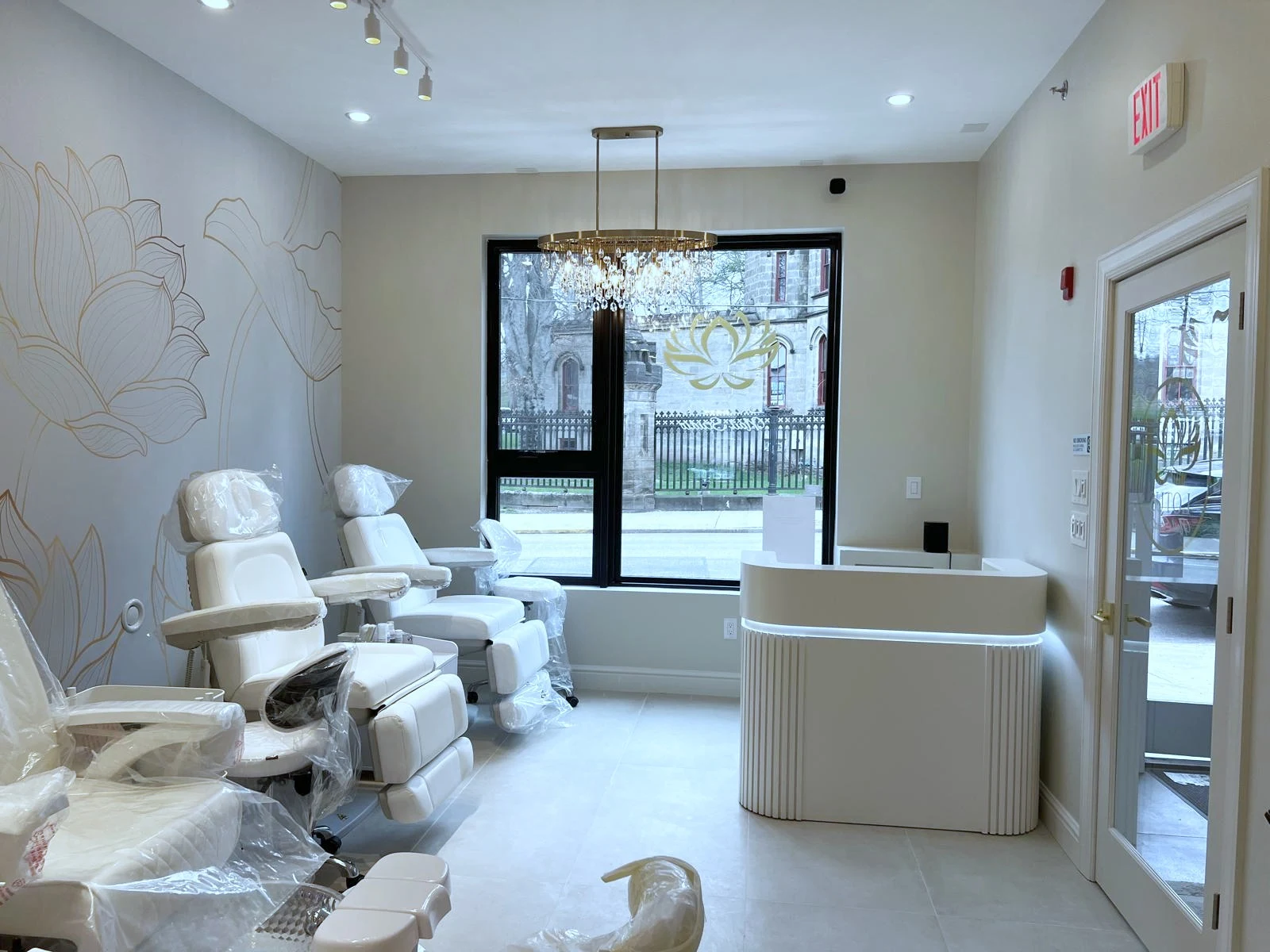 Secondary pedicure room with chandelier and Butler Street window