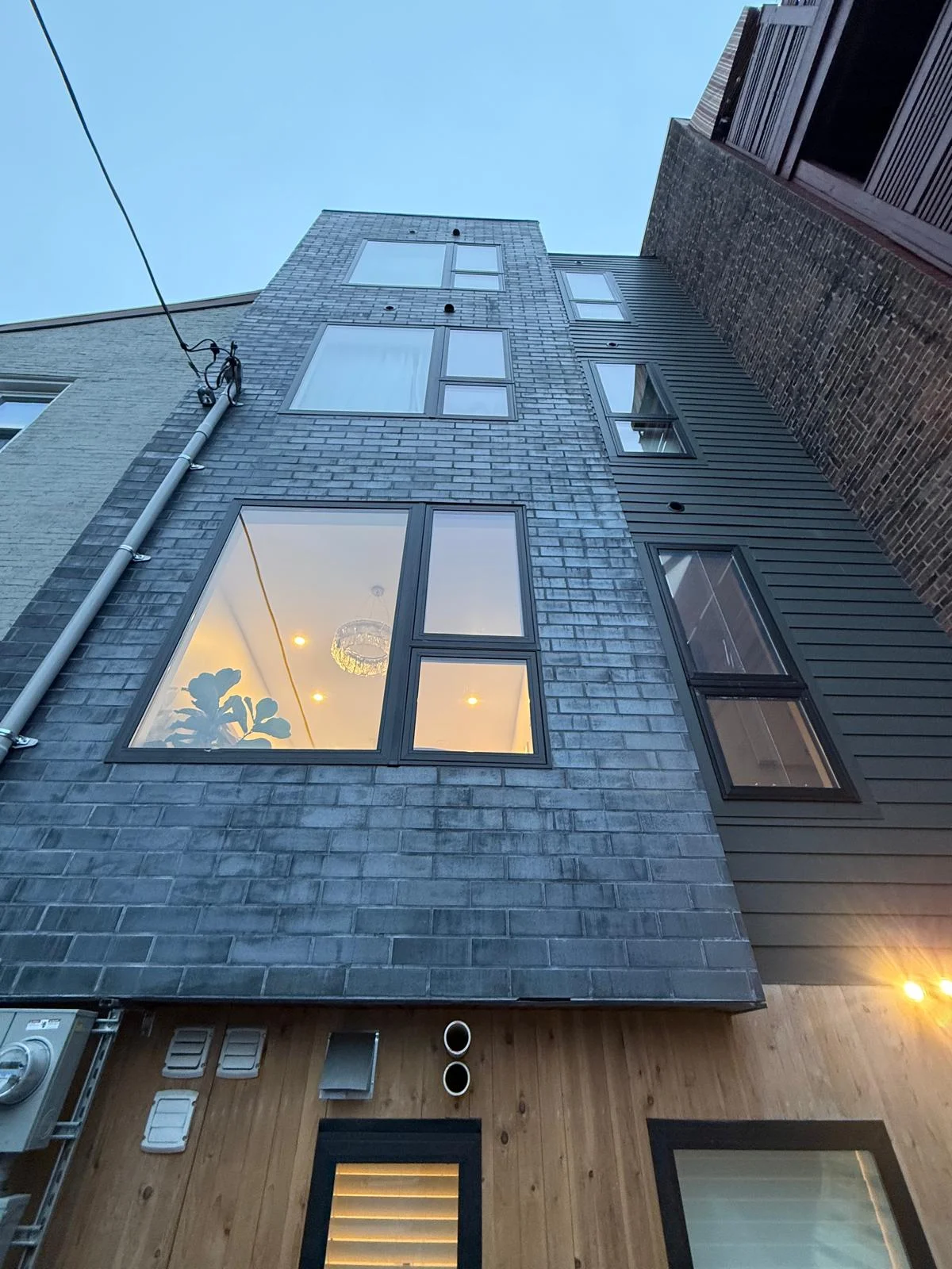 Mixed-use exterior — three floors of windows above the salon