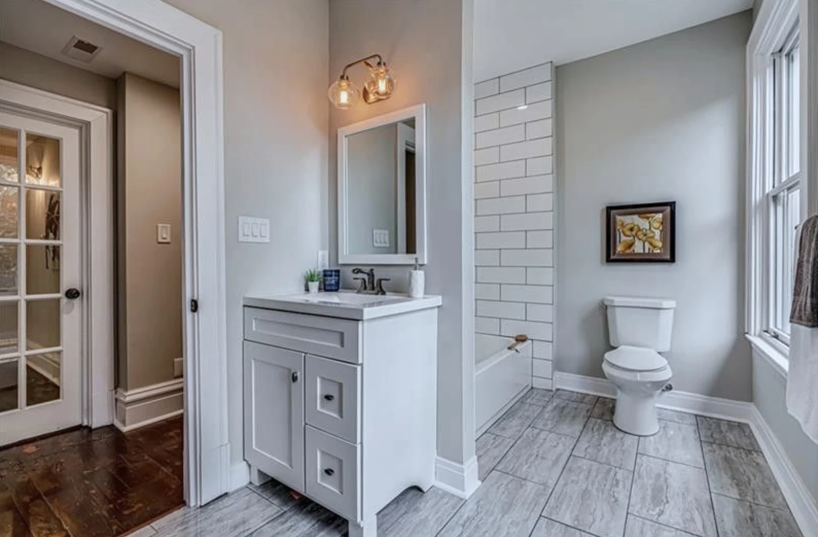 Powder room &mdash; gray vanity with sconce lighting