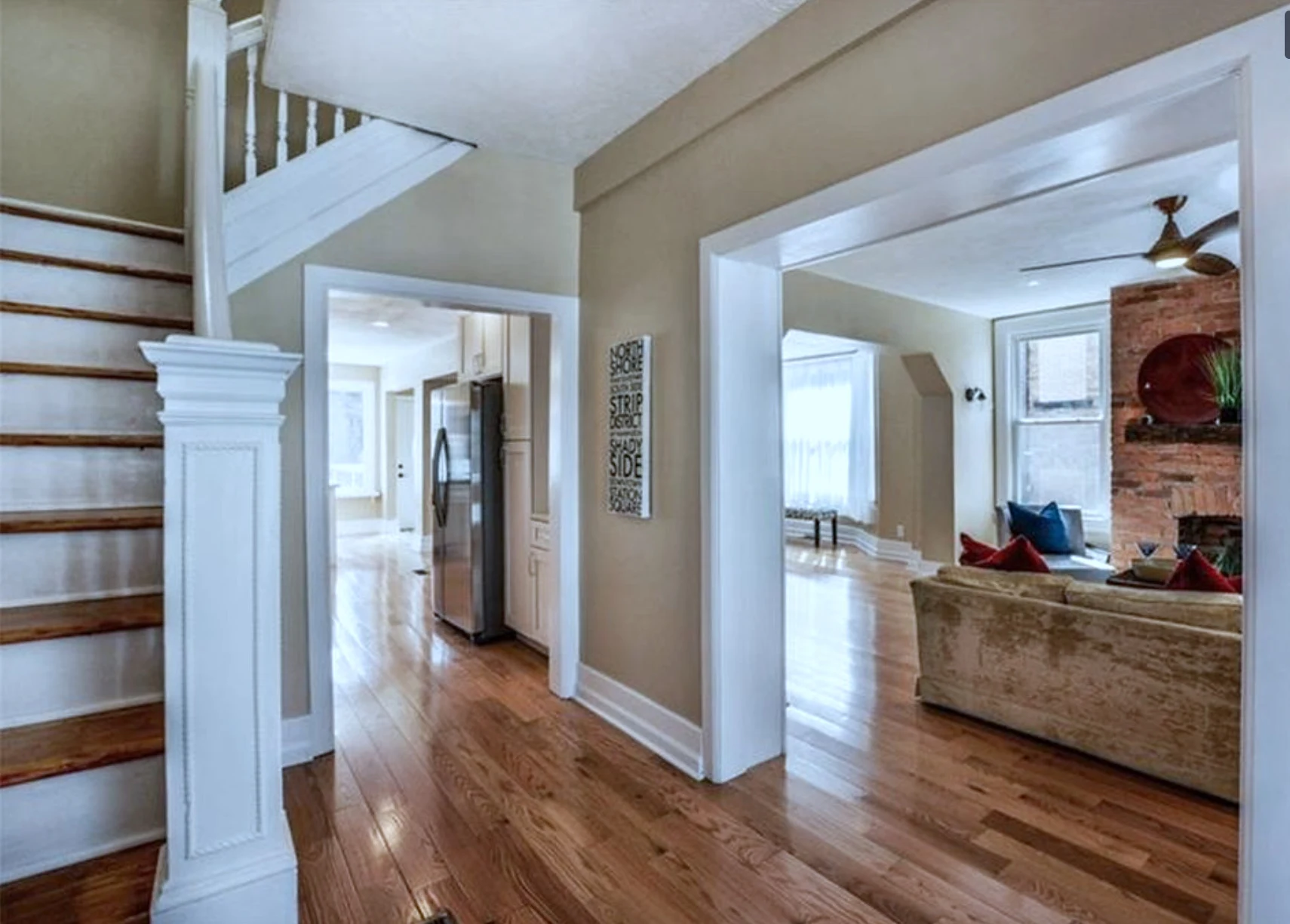 Entry hall — original staircase opening to kitchen and living room