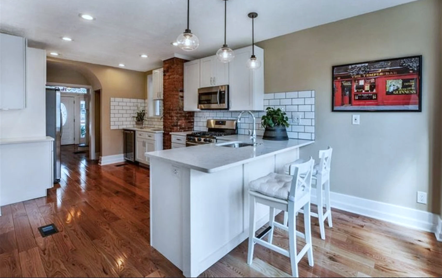 Kitchen &mdash; peninsula bar with pendant lighting