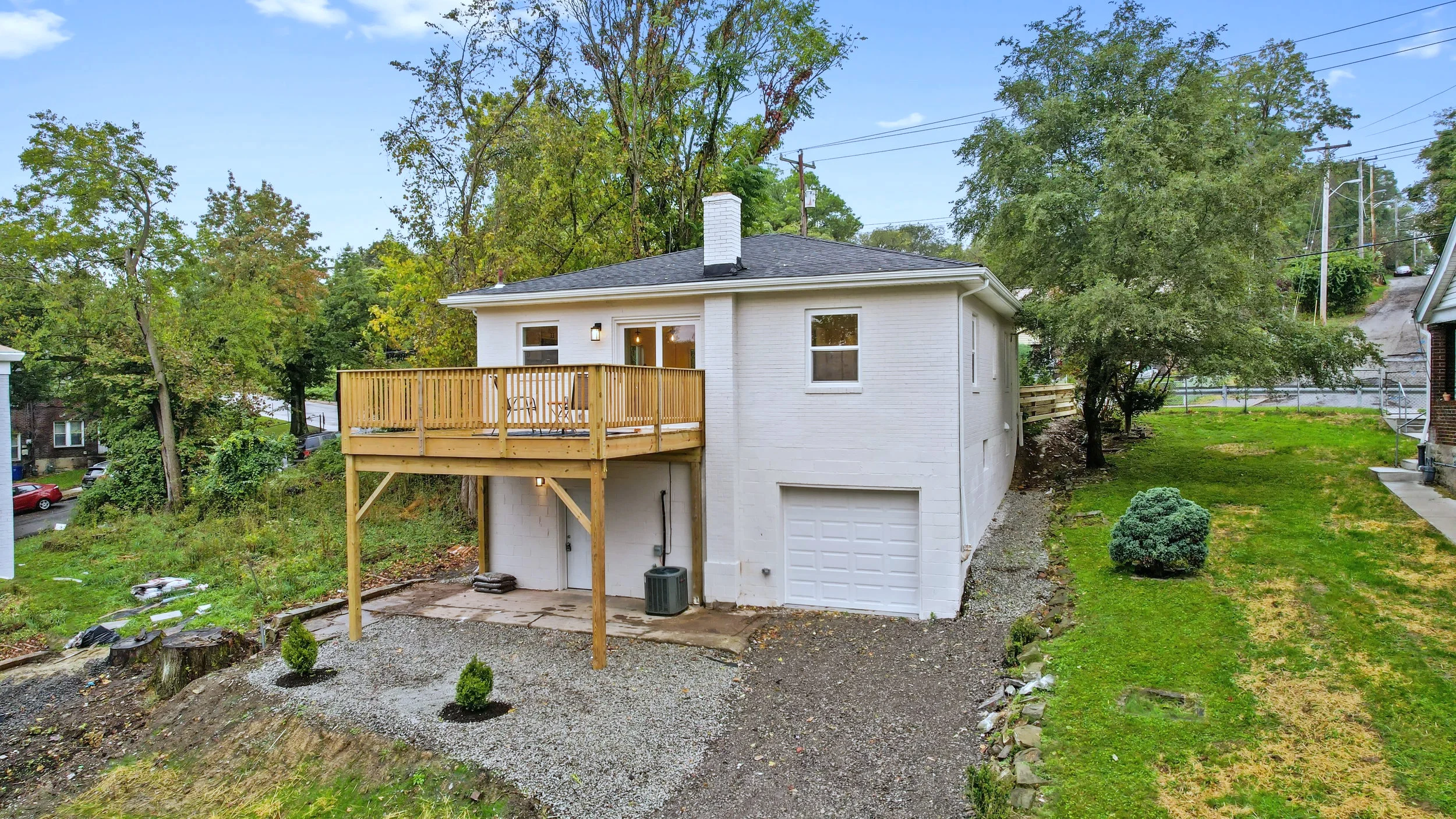 Exterior &mdash; restored single-story facade with new horizontal-slat cedar fence