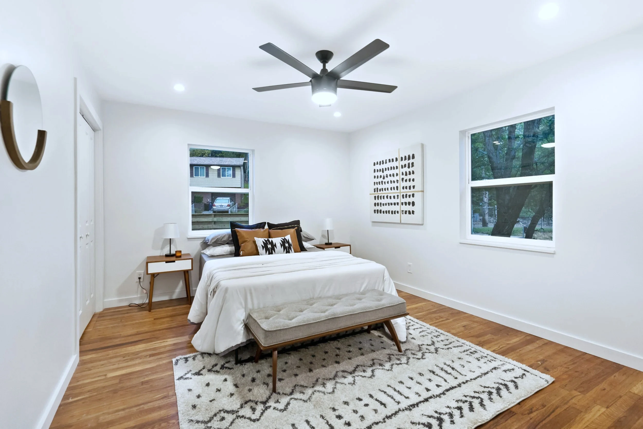 Primary bedroom &mdash; original room shape, new floors and windows