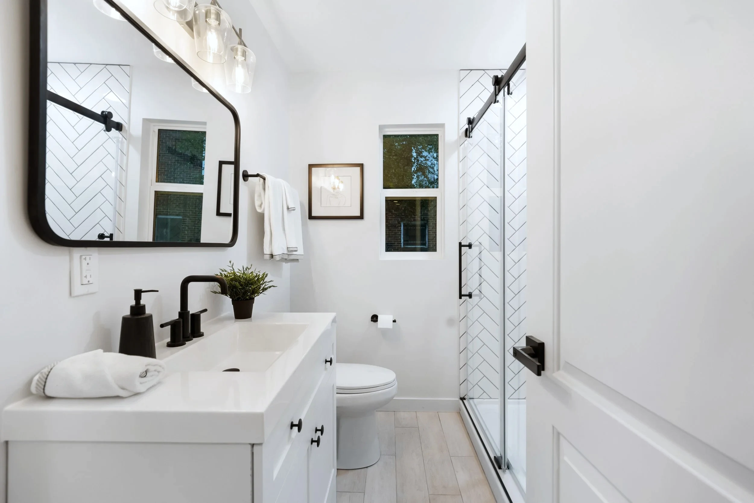 Primary bath &mdash; double vanity with marble top and matte black hardware