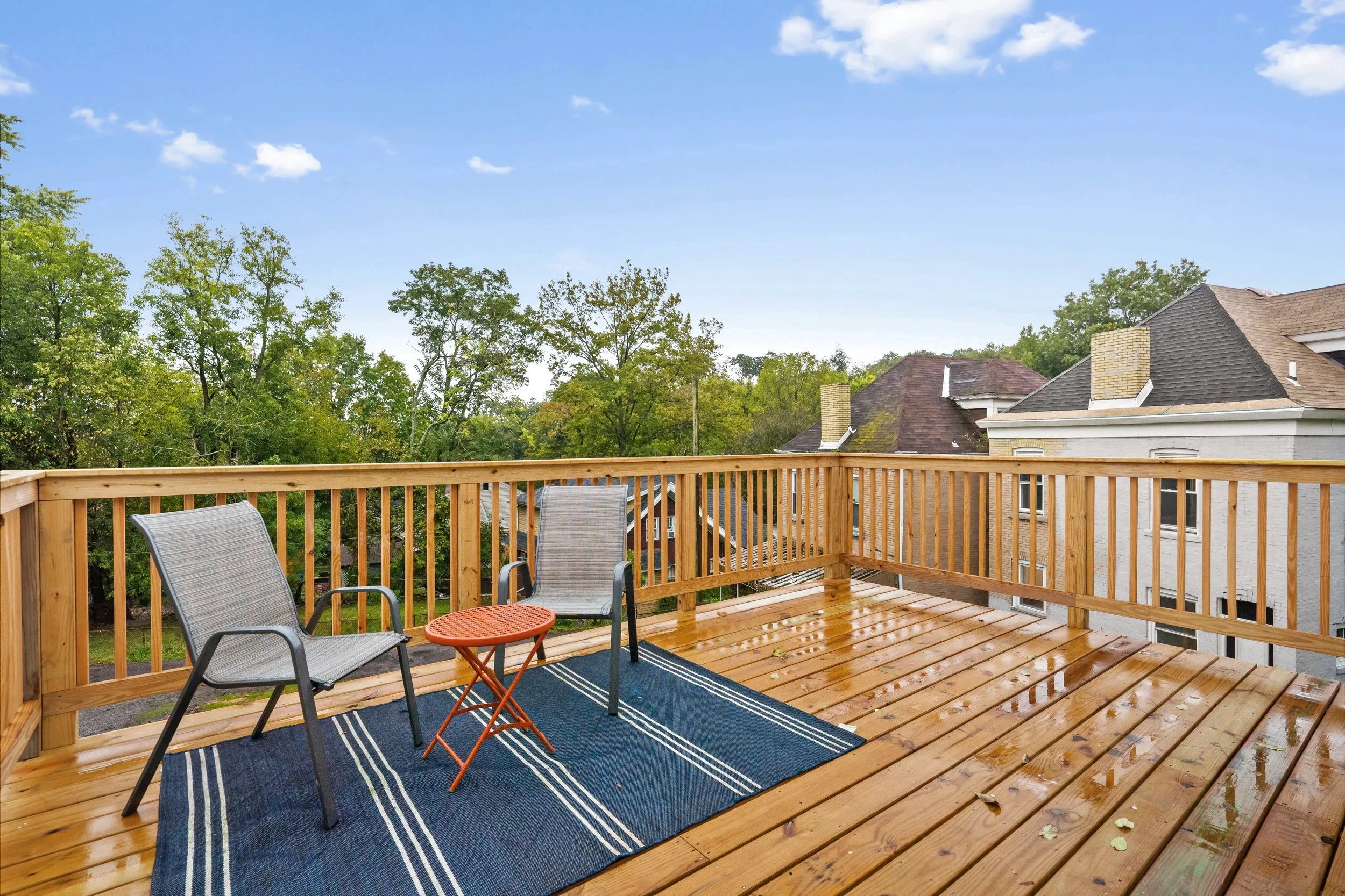 New back deck stepping off the kitchen into a fenced rear yard