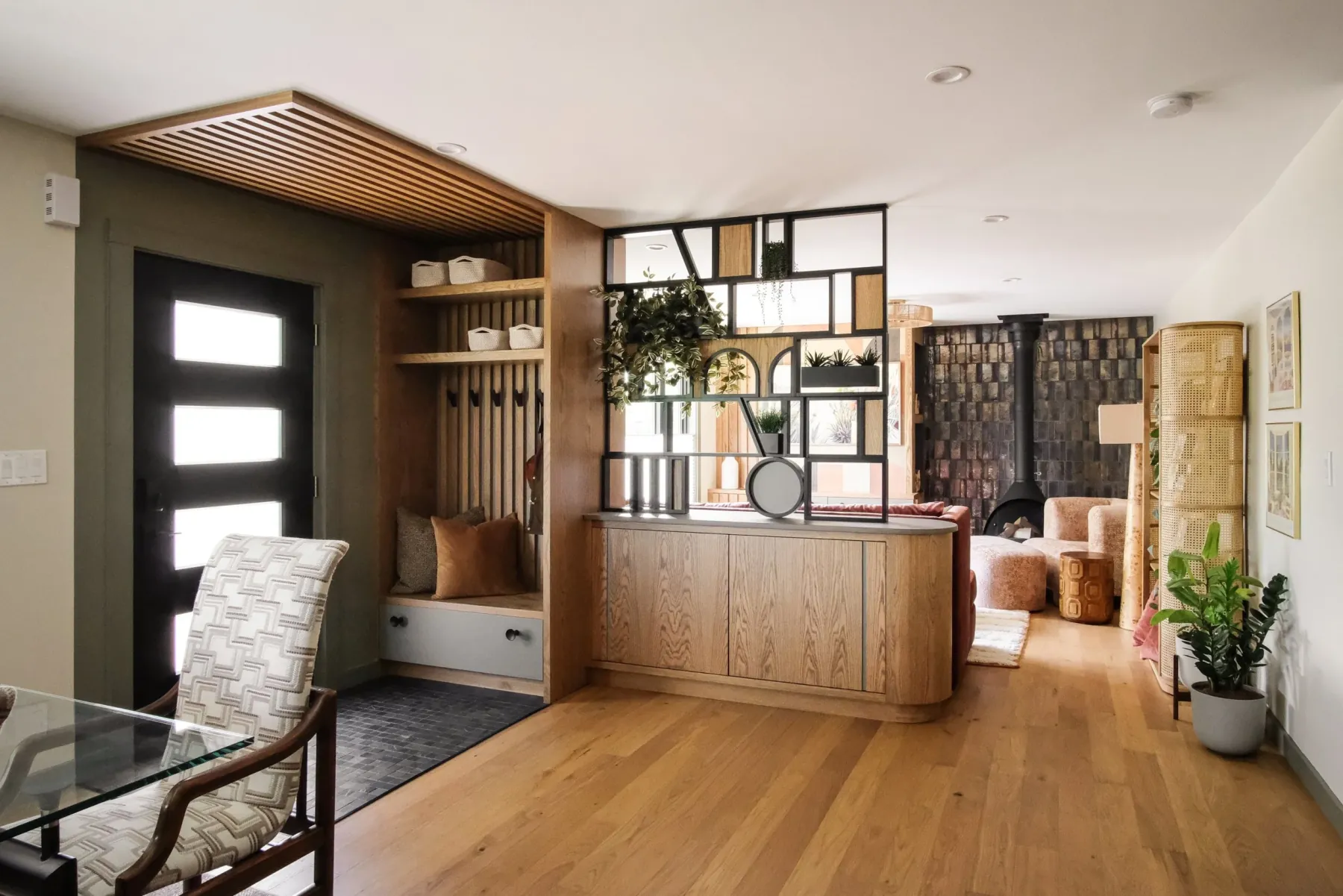 Highland Park home renovation, Pittsburgh — entry, white-oak built-ins and steel room divider looking into the living room