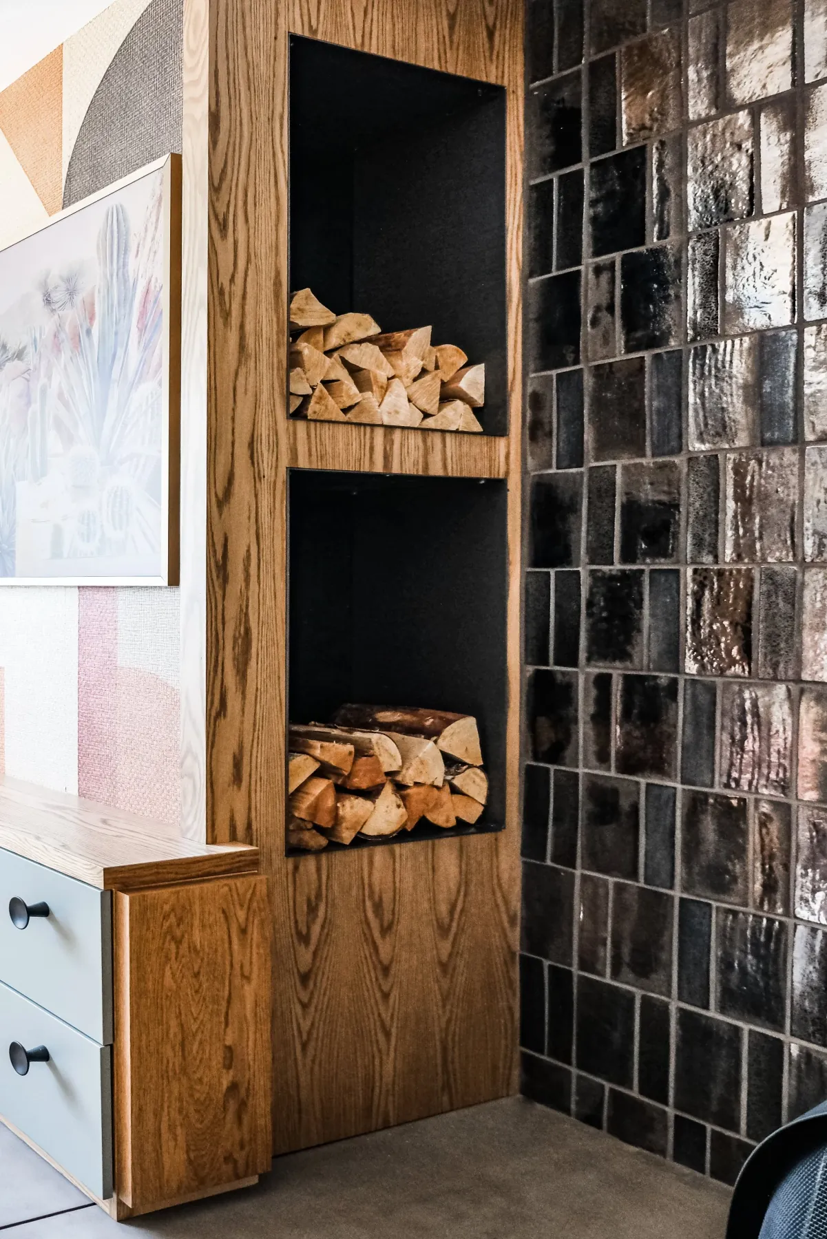 White-oak firewood storage niches built in beside the fireplace tile wall