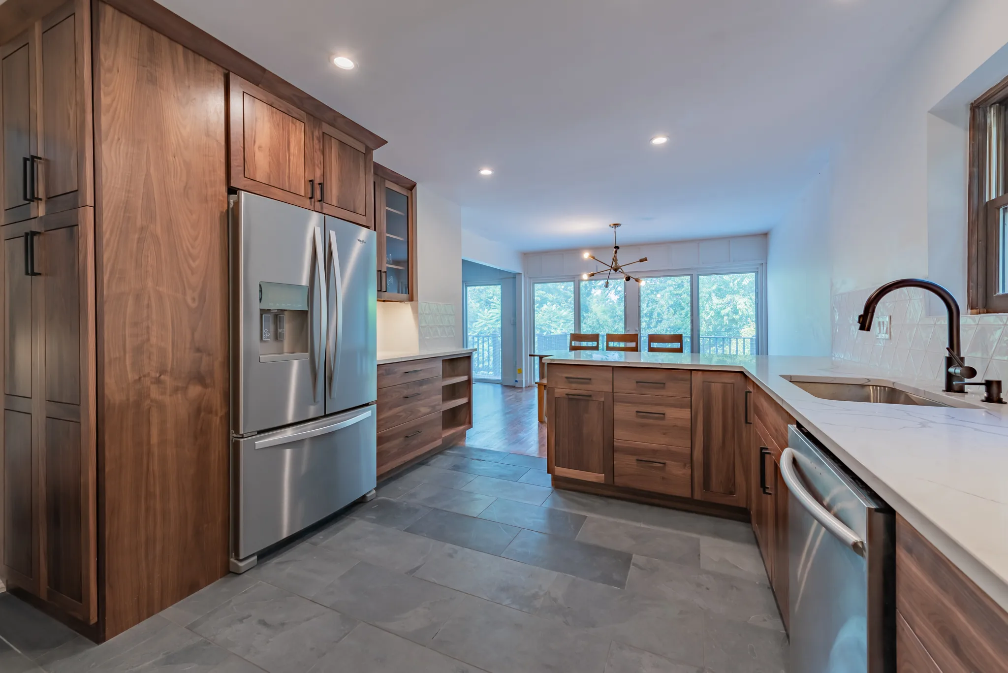 Walnut kitchen opening to a bright dining area with garden views in Point Breeze, Pittsburgh