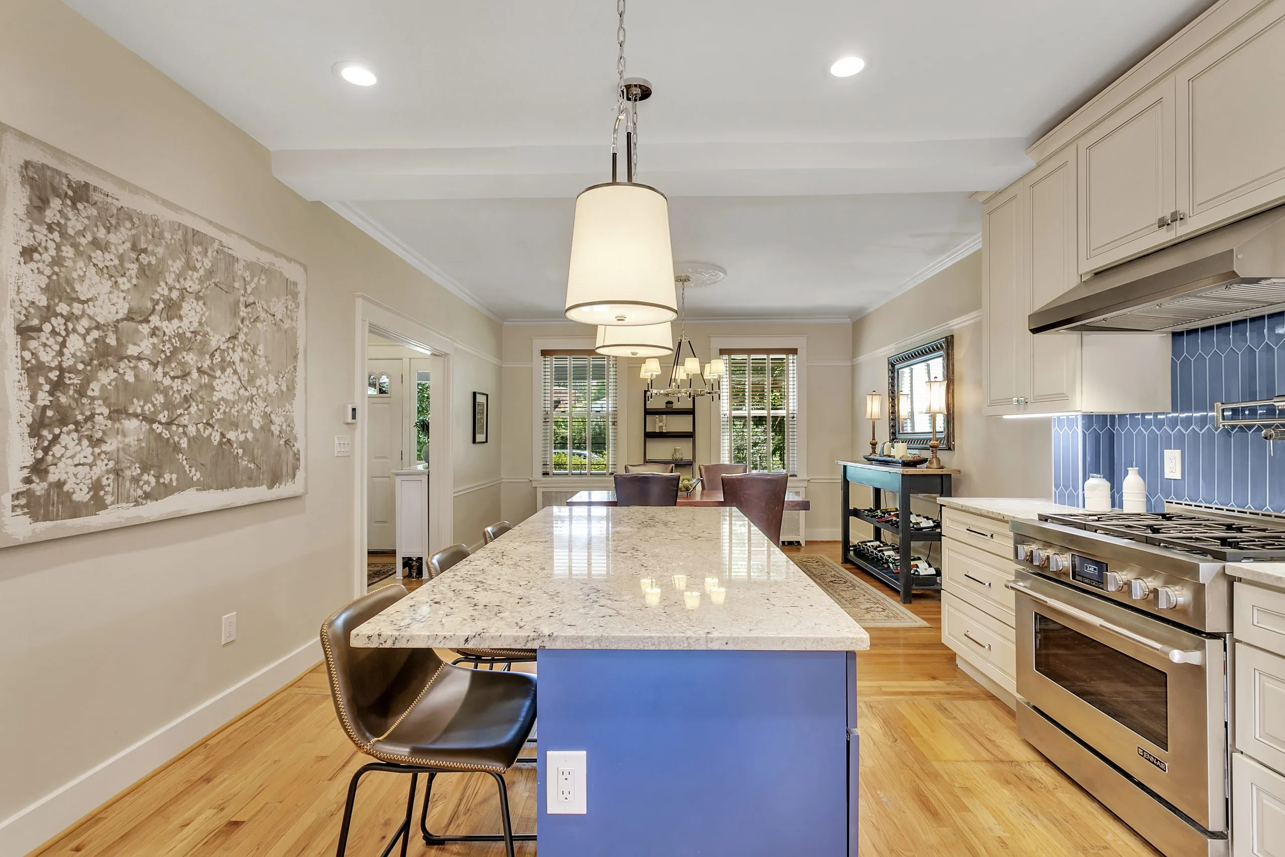 Open Point Breeze kitchen with a navy island, marble counters and a professional range, Pittsburgh