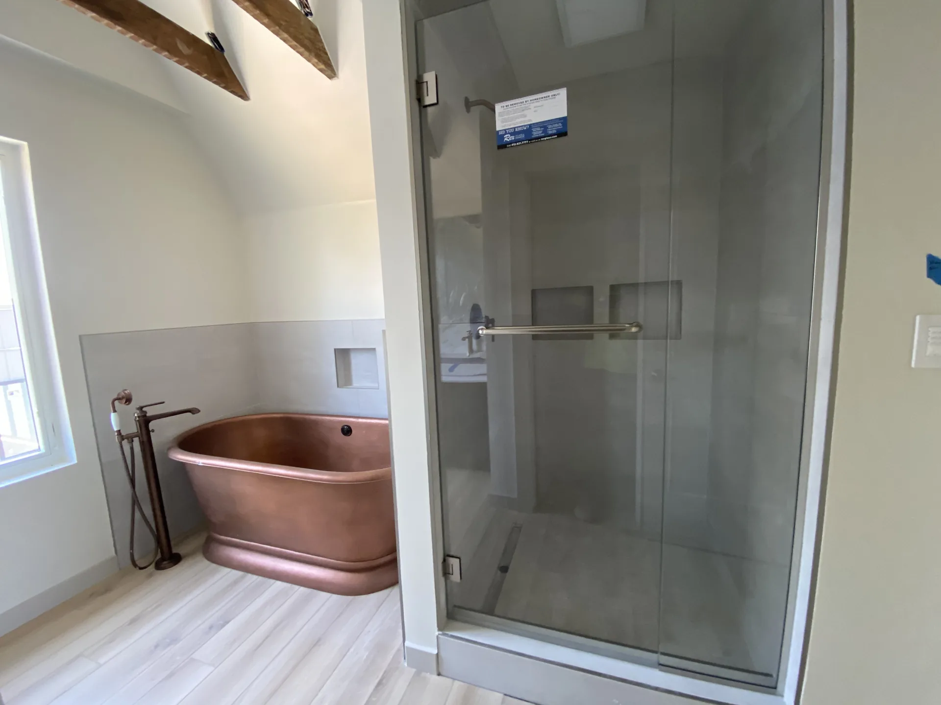 Modern Pittsburgh bathroom remodel with copper soaking tub and glass walk-in shower