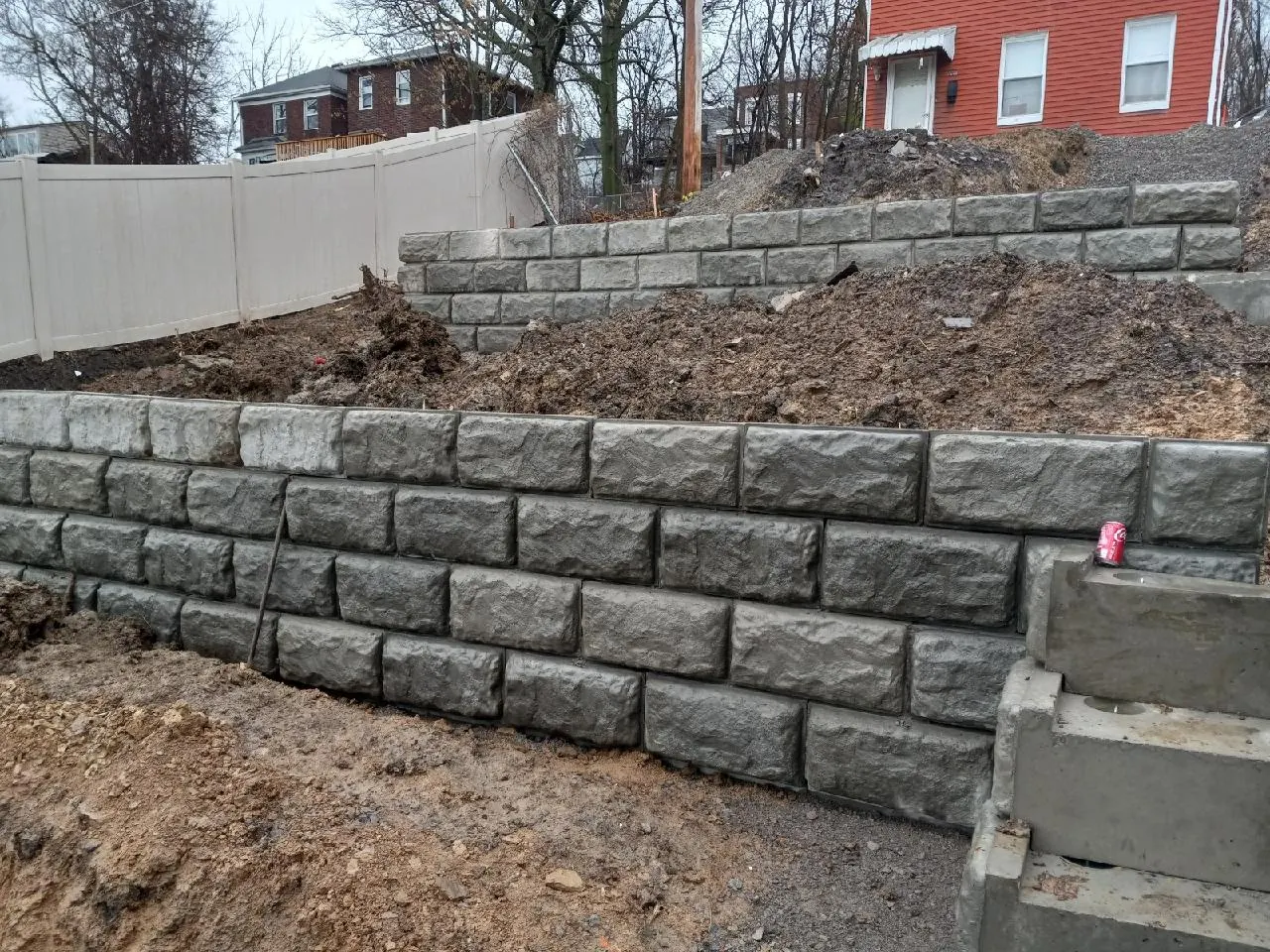 Two-tier segmental concrete block retaining wall built on a Pittsburgh slope