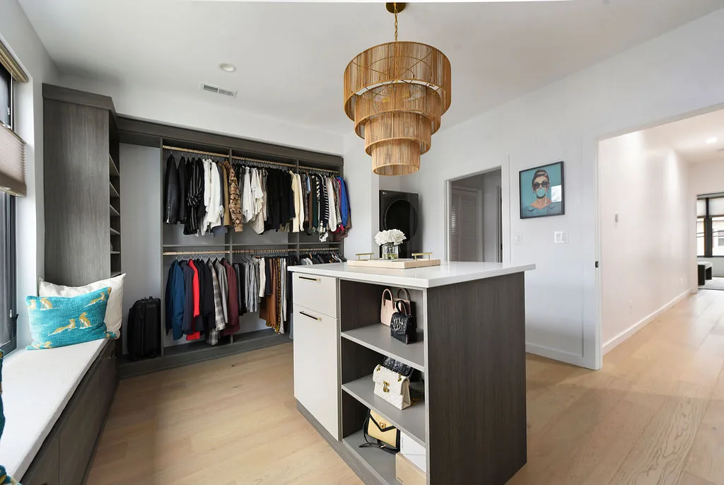 Custom walk-in dressing room with built-in cabinetry and island in a Pittsburgh custom home