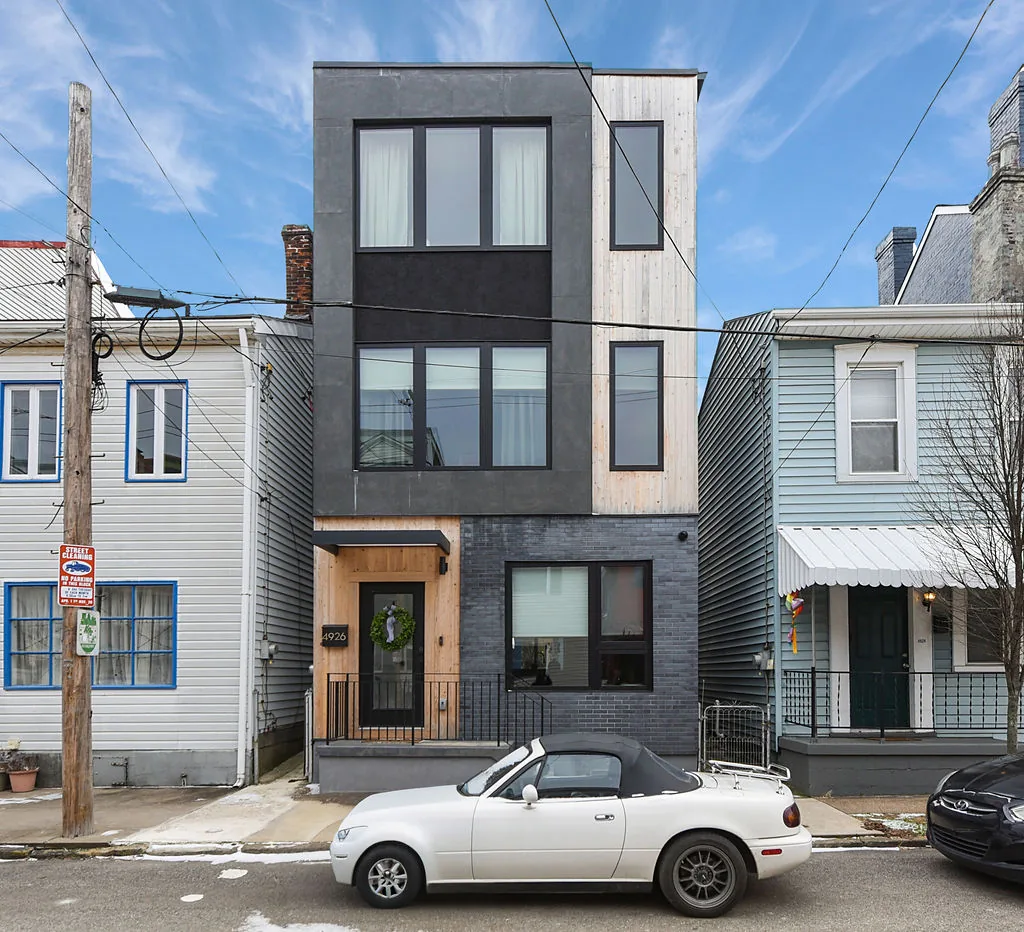Modern custom-built infill home in Pittsburgh on a narrow lot between two existing rowhouses