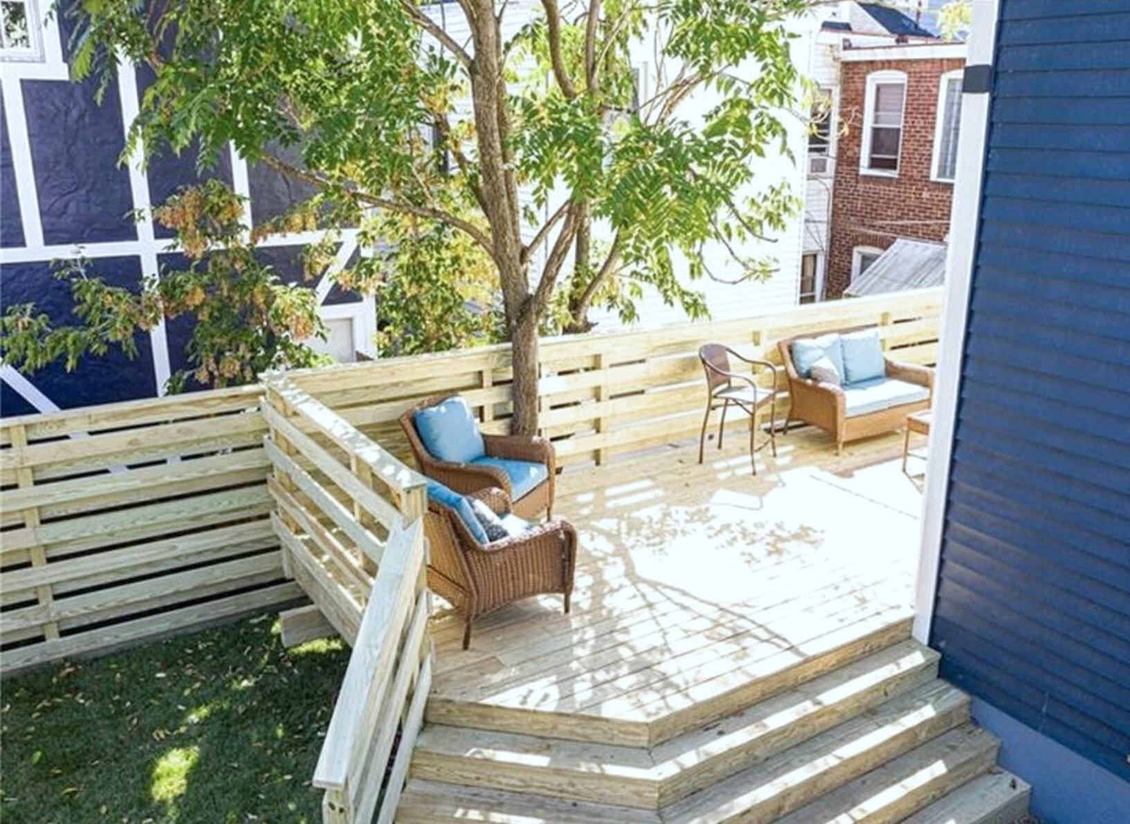 Multi-tier wood deck with a tree growing through it