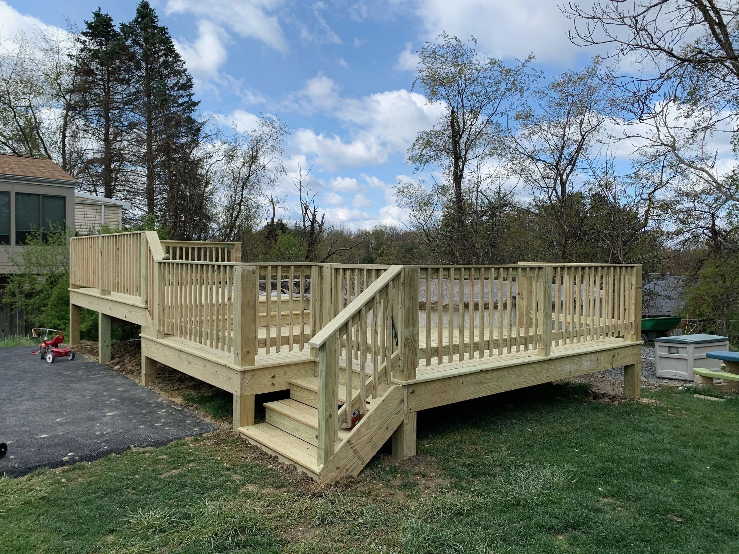 Multi-level pressure-treated deck with railings and stairs