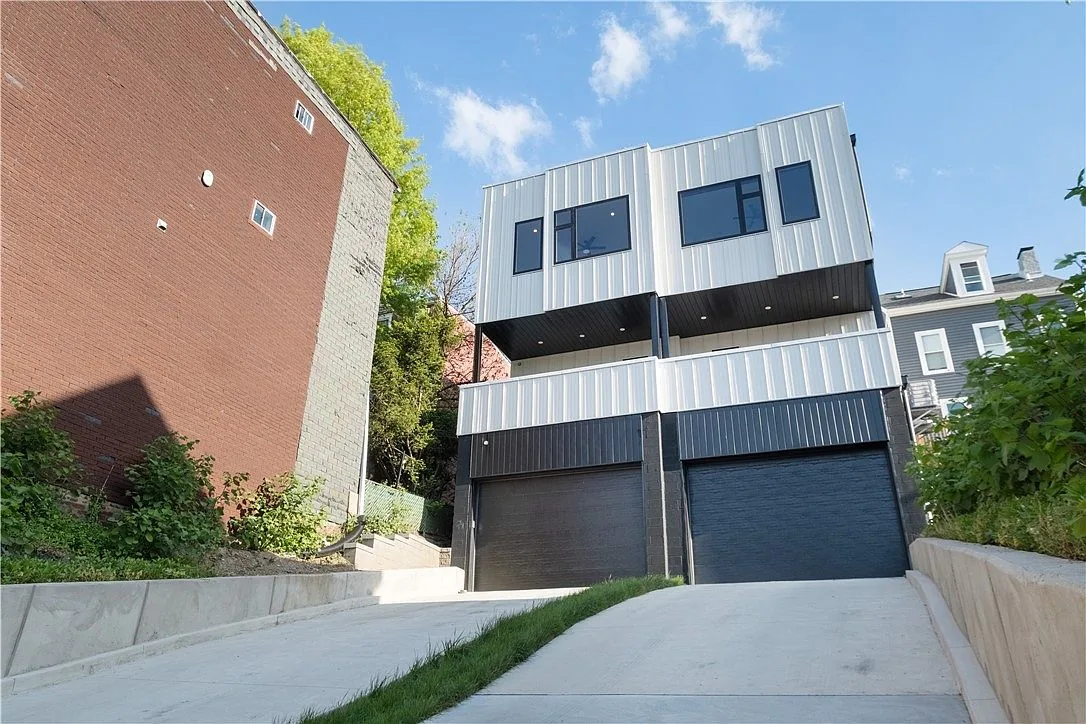 Modern Pittsburgh home with two tuck-under garage doors built into the lower level