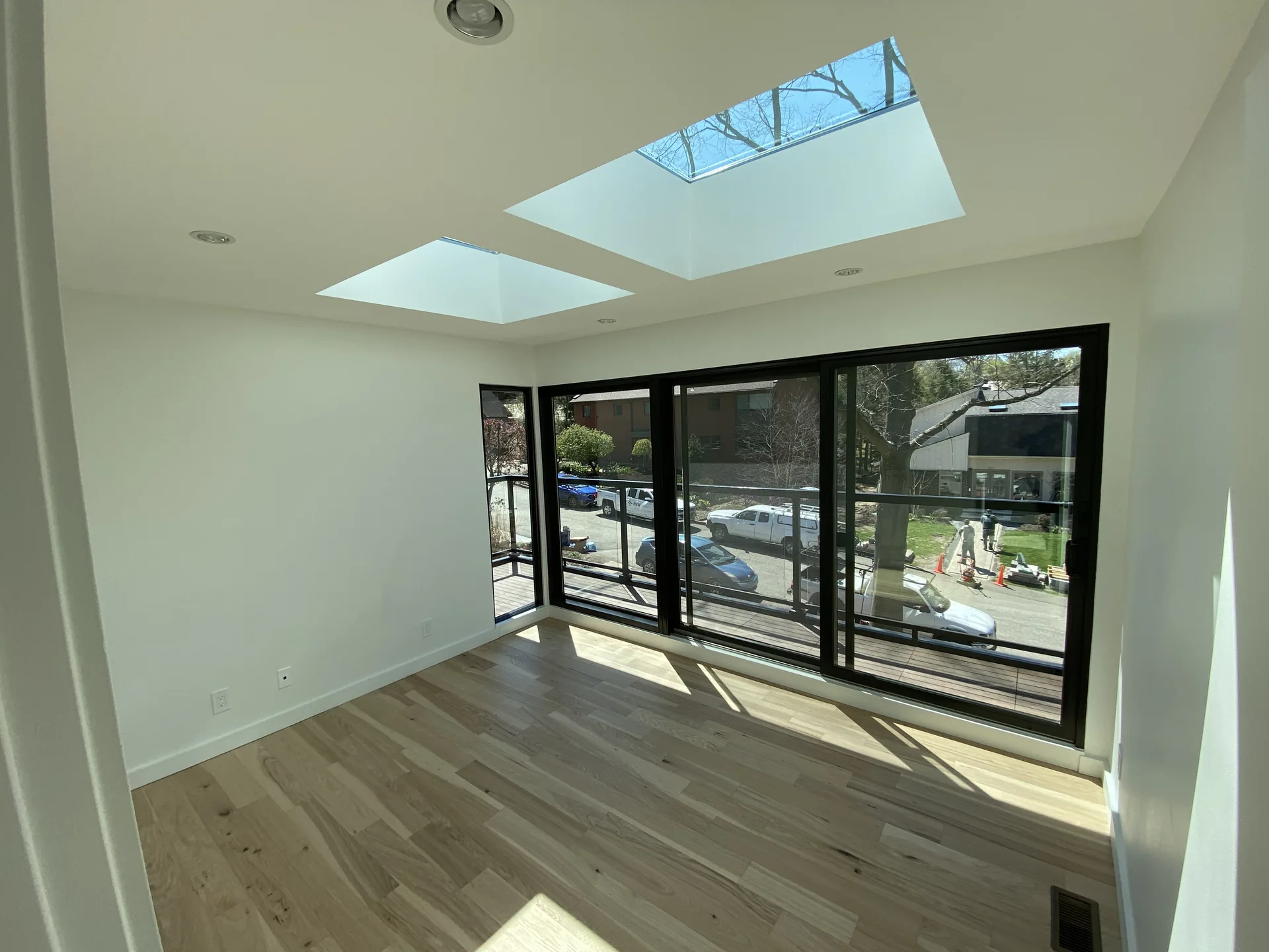 Bright open-plan commercial interior with floor-to-ceiling glass and skylights in Pittsburgh