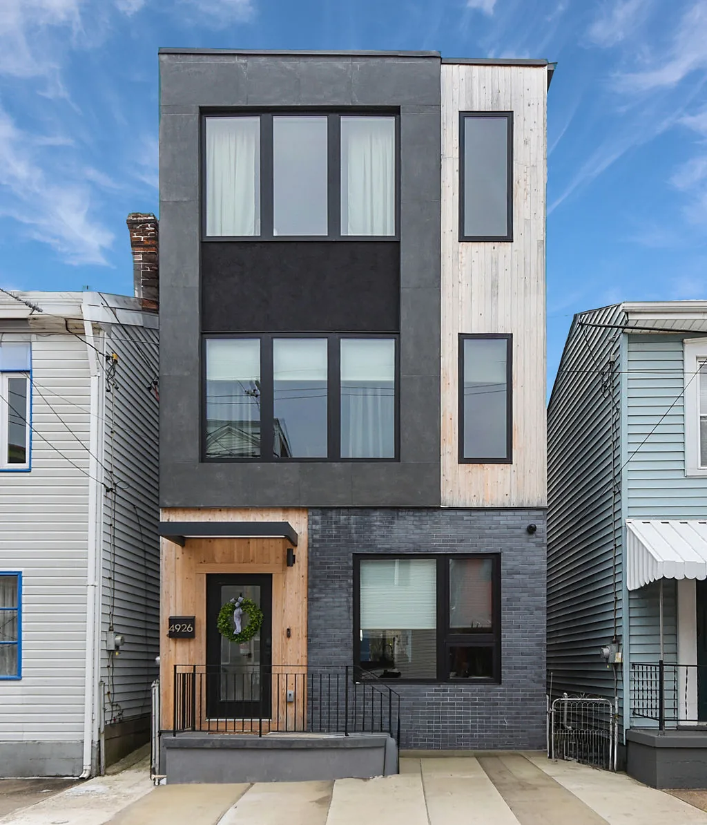 Three-story modern Pittsburgh home on a narrow lot, gaining a full top level between older neighbors