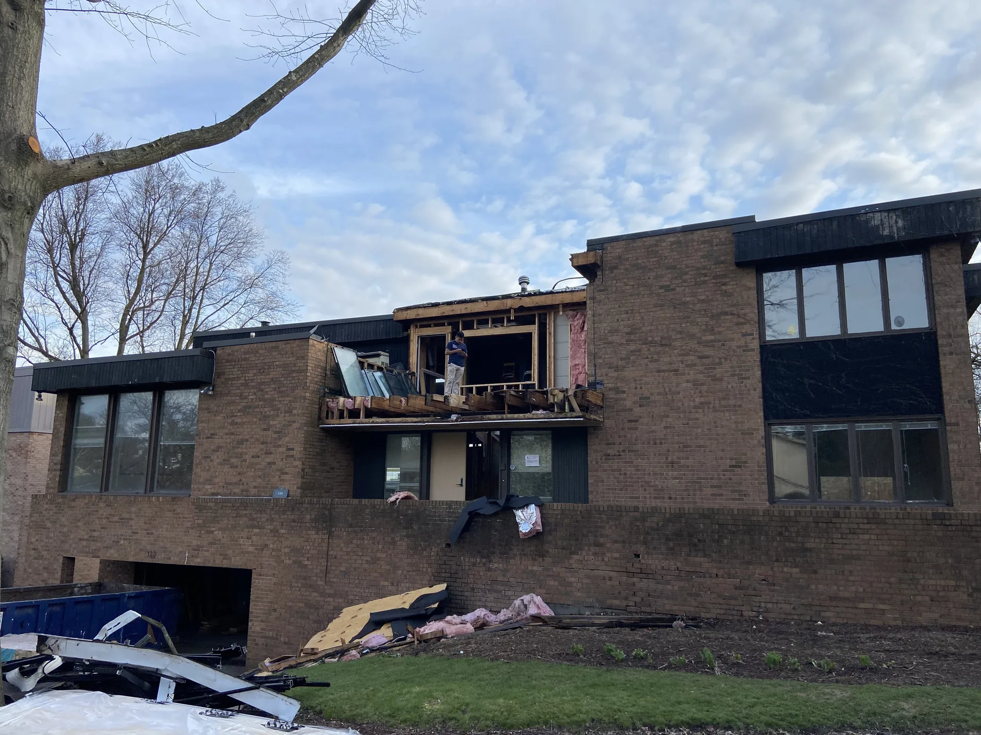Storm-damaged Pittsburgh house with an exposed exterior wall during whole-home gut renovation
