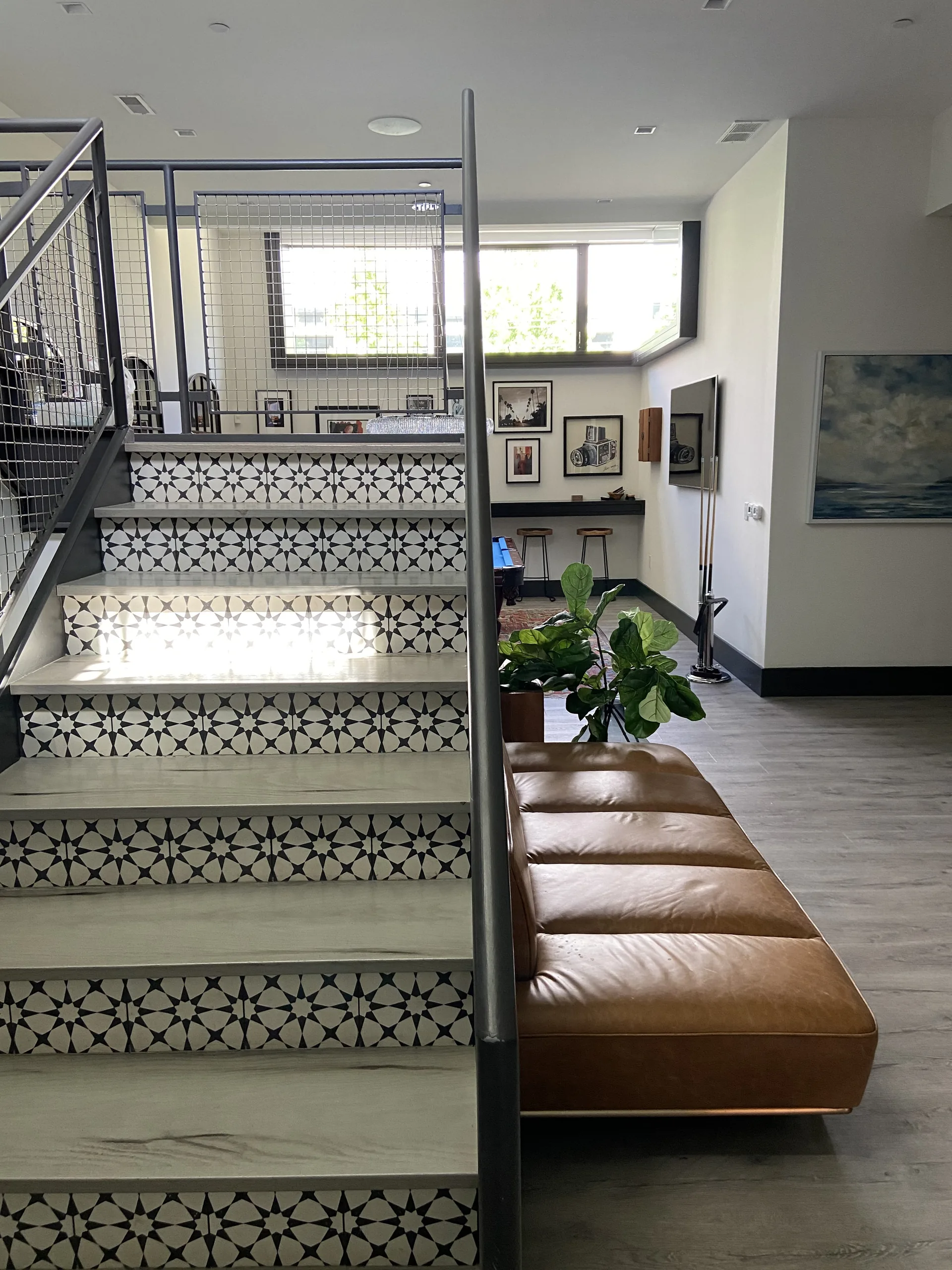 Renovated open stair with patterned-tile risers and oak floors in a Pittsburgh home